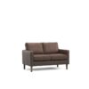 Brown two seater sofa in a dark room