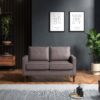 Grey two seater sofa in a dark room