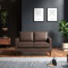 Brown two seater sofa in a dark room