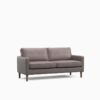 Grey three seater sofa in a dark room