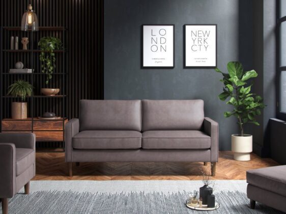 Grey three seater sofa in a dark room