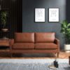 Tan three seater sofa in a dark room