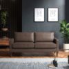 Brown three seater sofa in a dark room