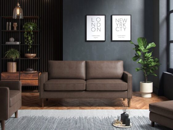 Brown three seater sofa in a dark room